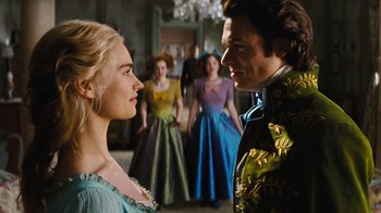 Movie still from “Cinderella” (2015), directed by Kenneth Branagh – A man and a woman standing next to each other in front of other people; Close Up shot, Over the shoulder angle