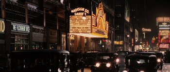 Movie still from “Cinderella Man” (2005), directed by Ron Howard – A theater sign lit up at night on a city street; Extreme Wide shot, High angle
