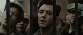 Movie still from “Cinderella Man” (2005), directed by Ron Howard – A person behind a fence; Close Up shot, Low angle