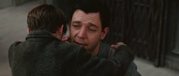 Movie still from “Cinderella Man” (2005), directed by Ron Howard – A man hugging another man with his arm around another man; Close Up shot, Over the shoulder angle