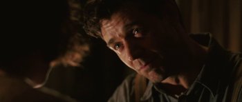 Movie still from “Cinderella Man” (2005), directed by Ron Howard – A man's face in the dark; Close Up shot, Over the shoulder angle