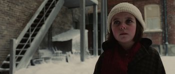 Movie still from “Cinderella Man” (2005), directed by Ron Howard – A young girl wearing a hat in the middle of the snow; Close Up shot, Over the shoulder angle