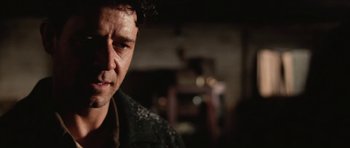 Movie still from “Cinderella Man” (2005), directed by Ron Howard – A man's face in a dark room; Close Up shot, Low angle