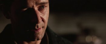 Movie still from “Cinderella Man” (2005), directed by Ron Howard – A man's face in the dark; Close Up shot, Over the shoulder angle