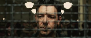 Movie still from “Cinderella Man” (2005), directed by Ron Howard – A person behind a fence; Close Up shot, Low angle