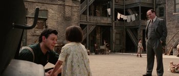 Movie still from “Cinderella Man” (2005), directed by Ron Howard – A man and a little girl are playing a game; Medium shot, Over the shoulder angle
