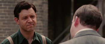 Movie still from “Cinderella Man” (2005), directed by Ron Howard – Two men are standing outside talking to each other; Close Up shot, Over the shoulder angle