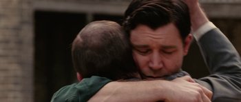 Movie still from “Cinderella Man” (2005), directed by Ron Howard – A man hugging another man with his arm around another man; Close Up shot, Low angle