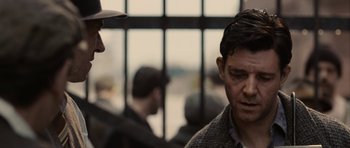 Movie still from “Cinderella Man” (2005), directed by Ron Howard – A man in a hat is talking to another man in a sweater; Close Up shot, Over the shoulder angle