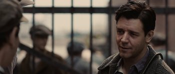 Movie still from “Cinderella Man” (2005), directed by Ron Howard – A person wearing a jacket near a window; Close Up shot, Over the shoulder angle