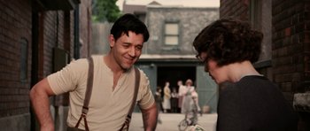 Movie still from “Cinderella Man” (2005), directed by Ron Howard – Two men talking to each other on the sidewalk; Medium shot, Over the shoulder angle