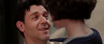 Movie still from “Cinderella Man” (2005), directed by Ron Howard – A man's face with a young boy; Close Up shot, Low angle