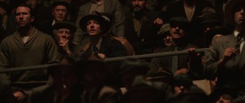 Movie still from “Cinderella Man” (2005), directed by Ron Howard – A group of men sitting next to each other in a crowd; Medium shot, High angle