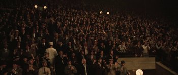Movie still from “Cinderella Man” (2005), directed by Ron Howard – A crowd of people standing in a dark room; Extreme Wide shot, High angle