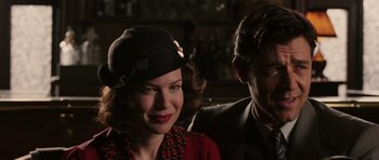 Movie still from “Cinderella Man” (2005), directed by Ron Howard – A man and a woman wearing hats and a suit; Close Up shot, Over the shoulder angle