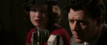 Movie still from “Cinderella Man” (2005), directed by Ron Howard – A man and a woman in front of a microphone; Close Up shot, Low angle