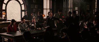 Movie still from “Cinderella Man” (2005), directed by Ron Howard – A group of people sitting at a table in a room; Wide shot, Over the shoulder angle