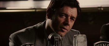 Movie still from “Cinderella Man” (2005), directed by Ron Howard – A person with a microphone; Close Up shot, Low angle