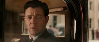 Movie still from “Cinderella Man” (2005), directed by Ron Howard – A person wearing a suit and tie; Close Up shot, Over the shoulder angle