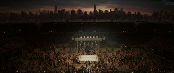Movie still from “Cinderella Man” (2005), directed by Ron Howard – A boxing ring in an arena with people watching it; Extreme Wide shot, High angle