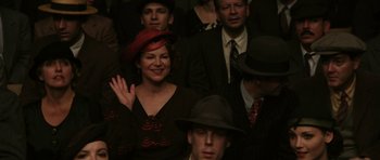 Movie still from “Cinderella Man” (2005), directed by Ron Howard – A group of men and women in suits and hats; Medium shot, Over the shoulder angle