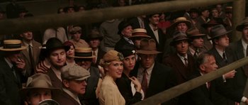 Movie still from “Cinderella Man” (2005), directed by Ron Howard – A group of people wearing hats in a boxing ring; Medium shot, High angle