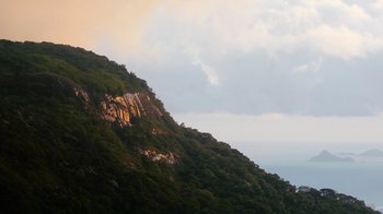 Movie still from “Citizenfour” (2014), directed by Laura Poitras – A view of a mountain side with trees on the side; Extreme Wide shot, Low angle