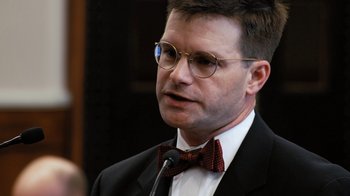Movie still from “Citizenfour” (2014), directed by Laura Poitras – A person wearing glasses and a bow tie; Close Up shot, Low angle