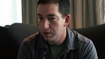 Movie still from “Citizenfour” (2014), directed by Laura Poitras – A person sitting on a couch; Close Up shot, High angle