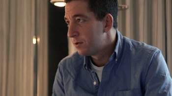 Movie still from “Citizenfour” (2014), directed by Laura Poitras – A person wearing a blue shirt; Close Up shot, High angle