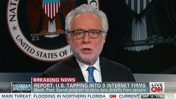 Movie still from “Citizenfour” (2014), directed by Laura Poitras – An older man in a suit and glasses is talking; Close Up shot, Low angle