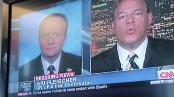 Movie still from “Citizenfour” (2014), directed by Laura Poitras – A television screen showing a news anchor and a news anchor; Close Up shot, Over the shoulder angle