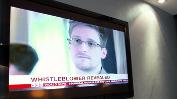 Movie still from “Citizenfour” (2014), directed by Laura Poitras – A television screen showing a news story with a picture of edward snowden; Extreme Close Up shot, Low angle