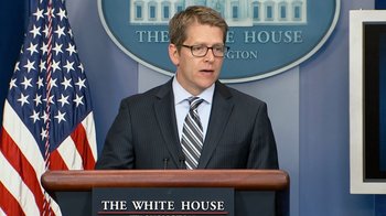 Movie still from “Citizenfour” (2014), directed by Laura Poitras – A man standing at a podium in front of the white house; Close Up shot, Low angle