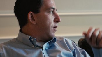 Movie still from “Citizenfour” (2014), directed by Laura Poitras – A person wearing a blue shirt; Close Up shot, Low angle