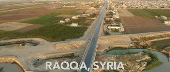 Movie still from “City of Ghosts” (2017), directed by Matthew Heineman – An aerial view of a road in the middle of the desert; Extreme Wide shot, High angle