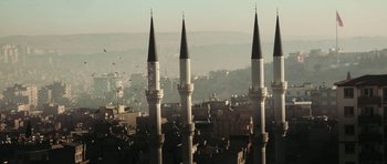 Movie still from “City of Ghosts” (2017), directed by Matthew Heineman – A view of a city from a high point of view; Extreme Wide shot, Low angle