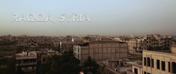 Movie still from “City of Ghosts” (2017), directed by Matthew Heineman – A view of a city from a high point of view; Extreme Wide shot, Low angle