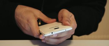 Movie still from “City of Ghosts” (2017), directed by Matthew Heineman – A person holding a cell phone in their hands; Extreme Close Up shot, Overhead angle