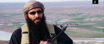 Movie still from “City of Ghosts” (2017), directed by Matthew Heineman – A man with a beard holding a gun in his hand; Close Up shot, Overhead angle
