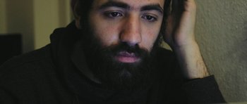 Movie still from “City of Ghosts” (2017), directed by Matthew Heineman – A person with a beard; Close Up shot, High angle