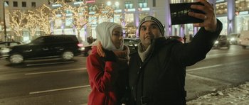 Movie still from “City of Ghosts” (2017), directed by Matthew Heineman – A man and a woman standing next to each other on the street; Close Up shot, Low angle
