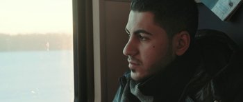 Movie still from “City of Ghosts” (2017), directed by Matthew Heineman – A person wearing a jacket; Close Up shot, Low angle