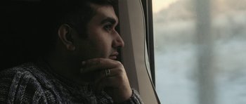 Movie still from “City of Ghosts” (2017), directed by Matthew Heineman – A person looking out a window; Close Up shot, Low angle