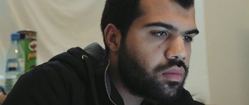 Movie still from “City of Ghosts” (2017), directed by Matthew Heineman – A person with a beard; Close Up shot, Low angle