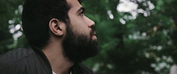 Movie still from “City of Ghosts” (2017), directed by Matthew Heineman – A person with a beard; Close Up shot, Low angle