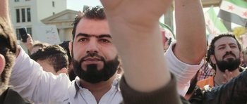Movie still from “City of Ghosts” (2017), directed by Matthew Heineman – A person with a beard; Close Up shot, Low angle