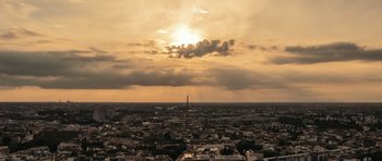 Movie still from “City of Ghosts” (2017), directed by Matthew Heineman – The sun is setting over a large city; Extreme Wide shot, High angle