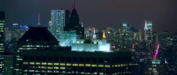 Movie still from “City of Ghosts” (2017), directed by Matthew Heineman – A view of a city skyline at night from a building; Extreme Wide shot, High angle