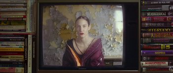 Movie still from “Climax” (2018), directed by Gaspar Noé – A woman is sitting in front of an old tv screen; Close Up shot, Over the shoulder angle